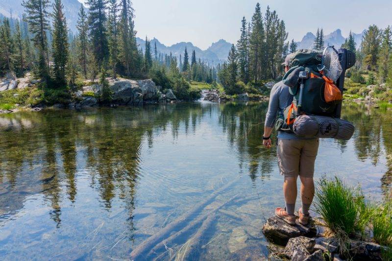 Backpacker in front of a lake