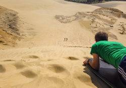 Sliding down on a sandboard