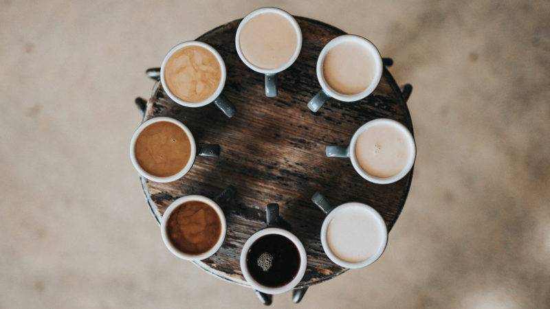 Different Coffee varieties set up on a round wooden table